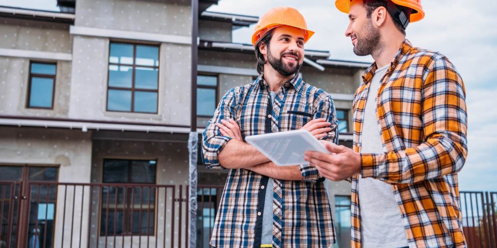 happy-architects-using-digital-tablet-at-construction-site-1.jpg